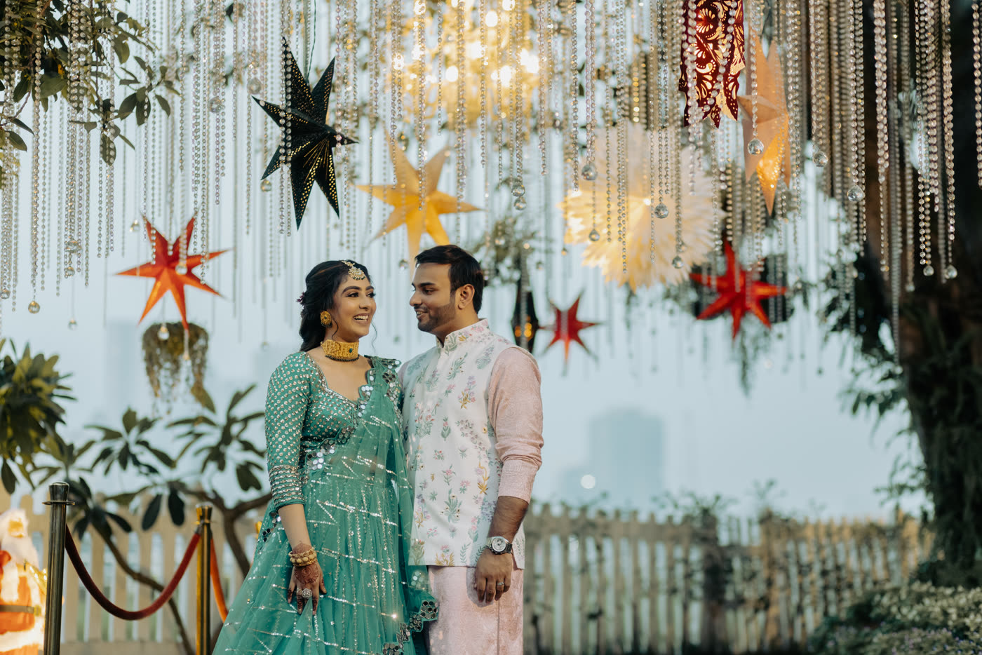 A couple at their reception beneath hanging stars