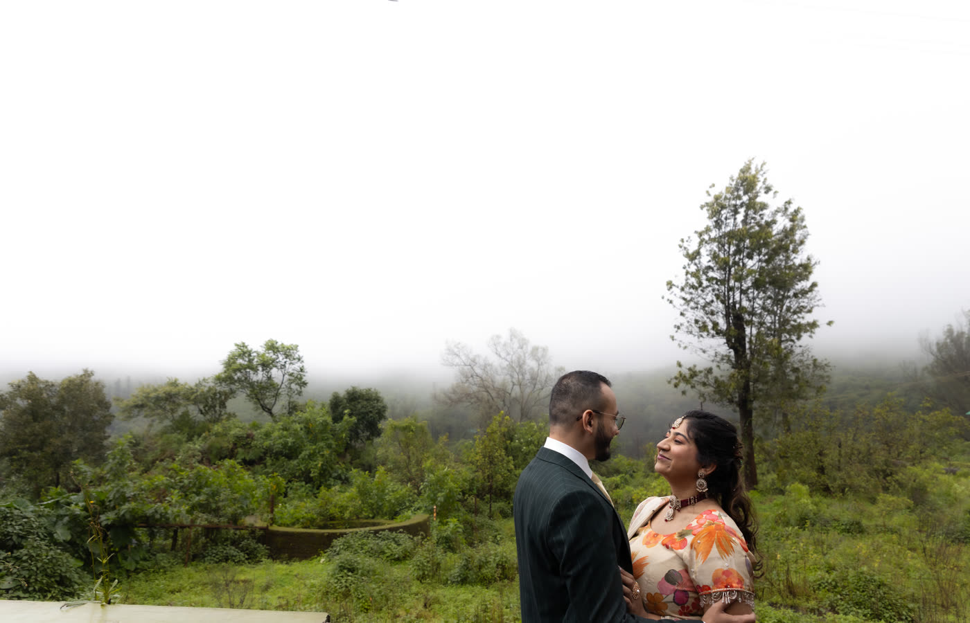 A couple on a hillside in the open air