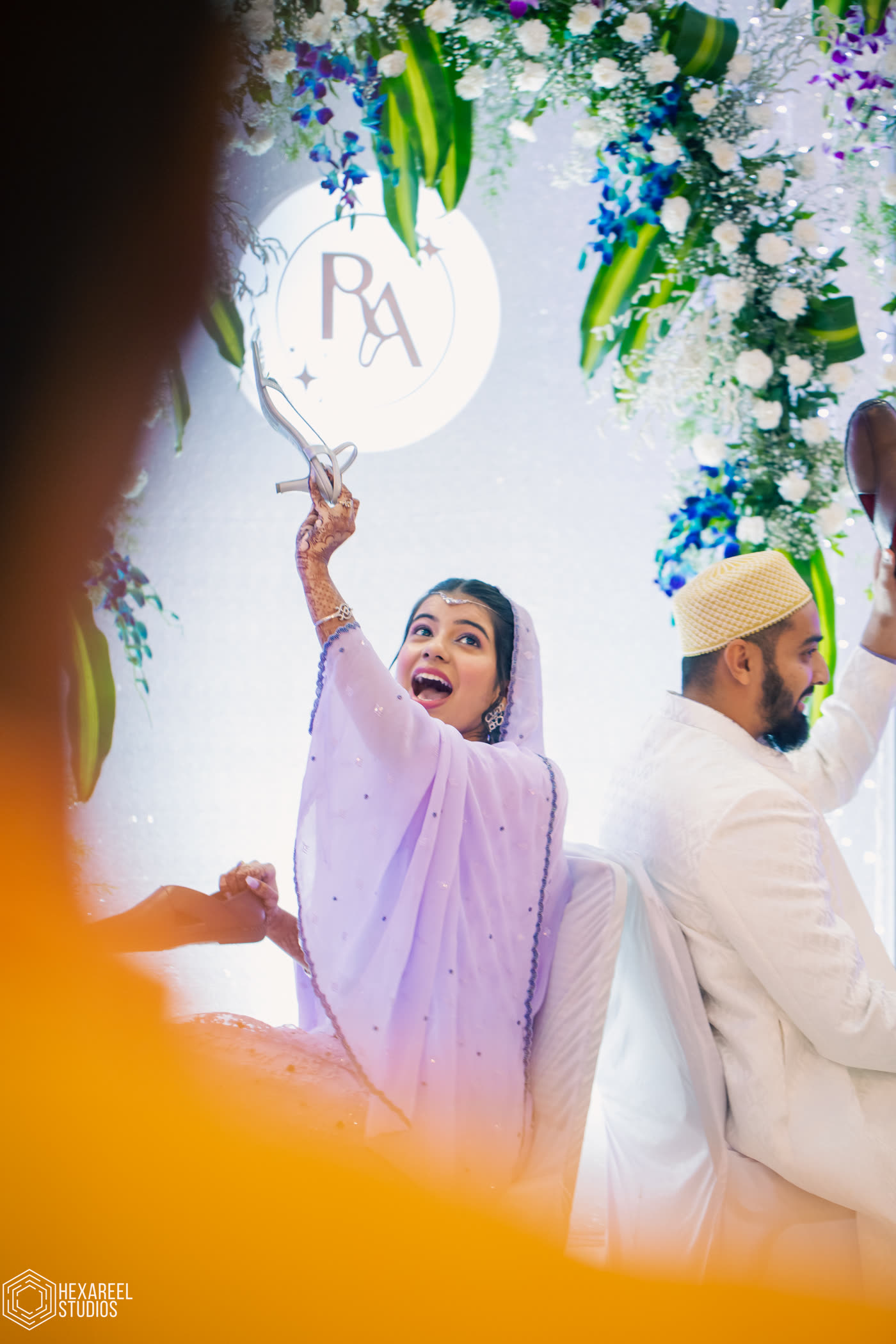 A bride glowing in golden light, sign held high