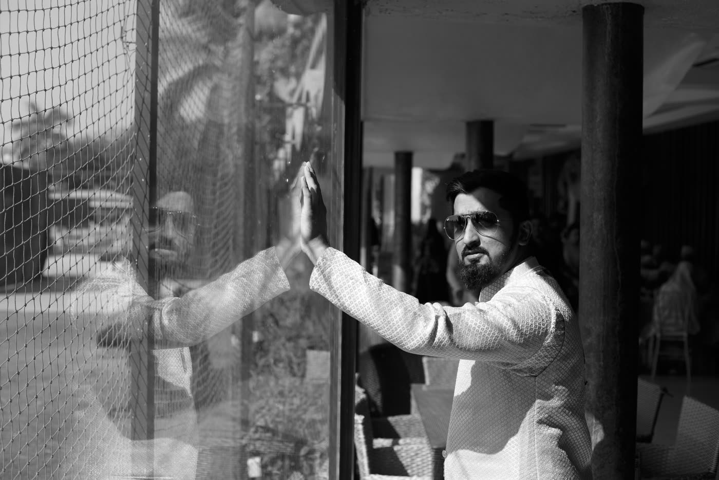 A groom's reflection, in black and white