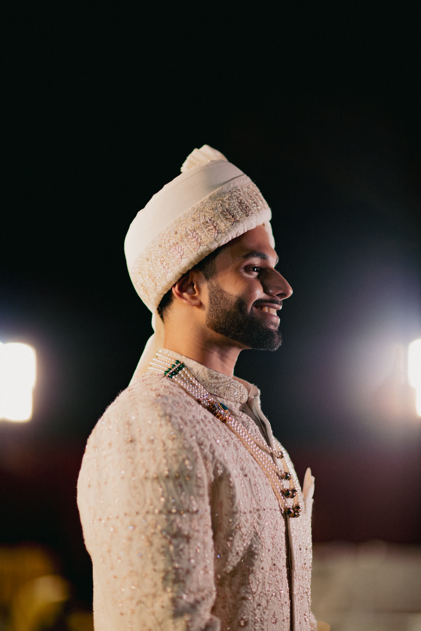 A groom lit against the night