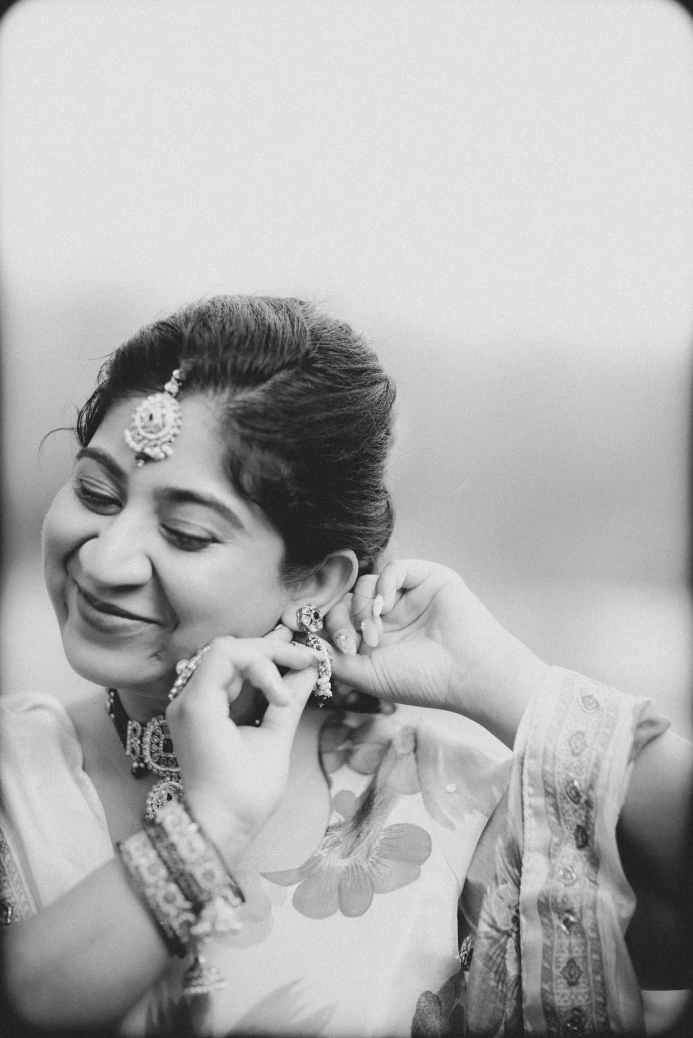 A bride getting ready, in black and white