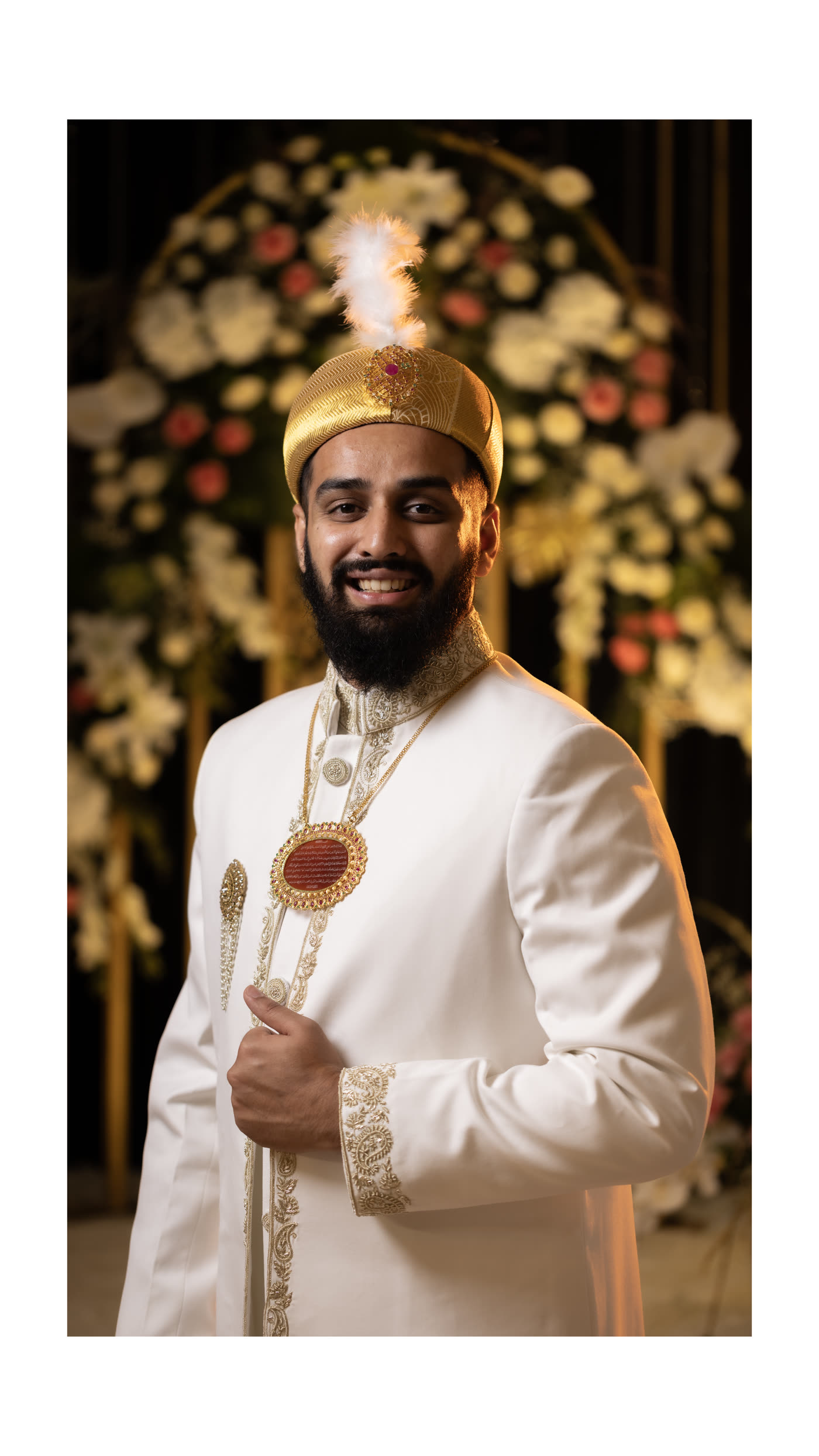 A groom in white and gold at his ceremony