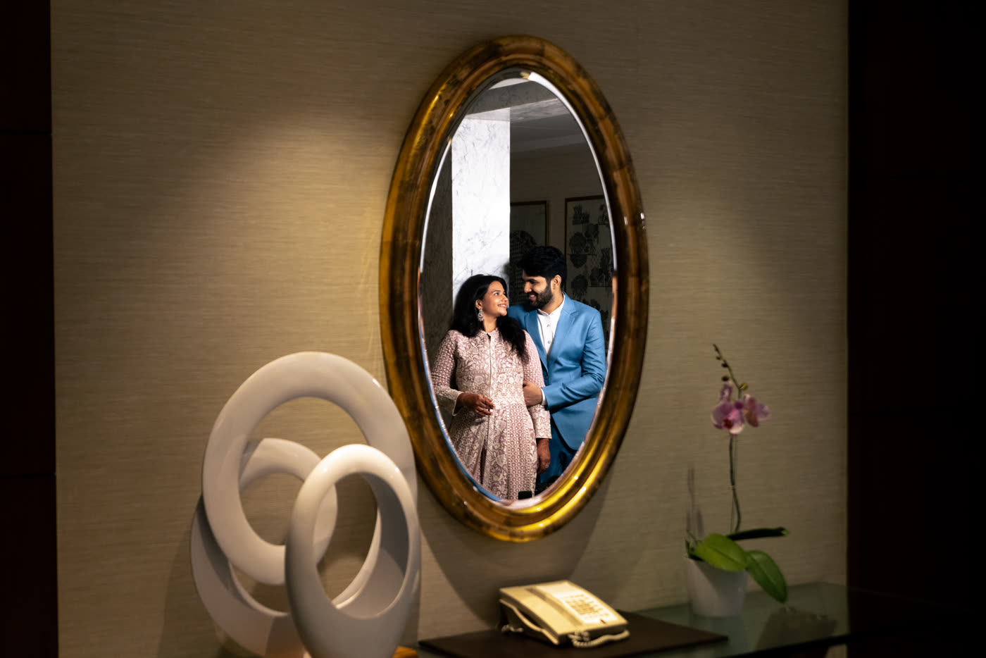 A couple reflected in a golden mirror