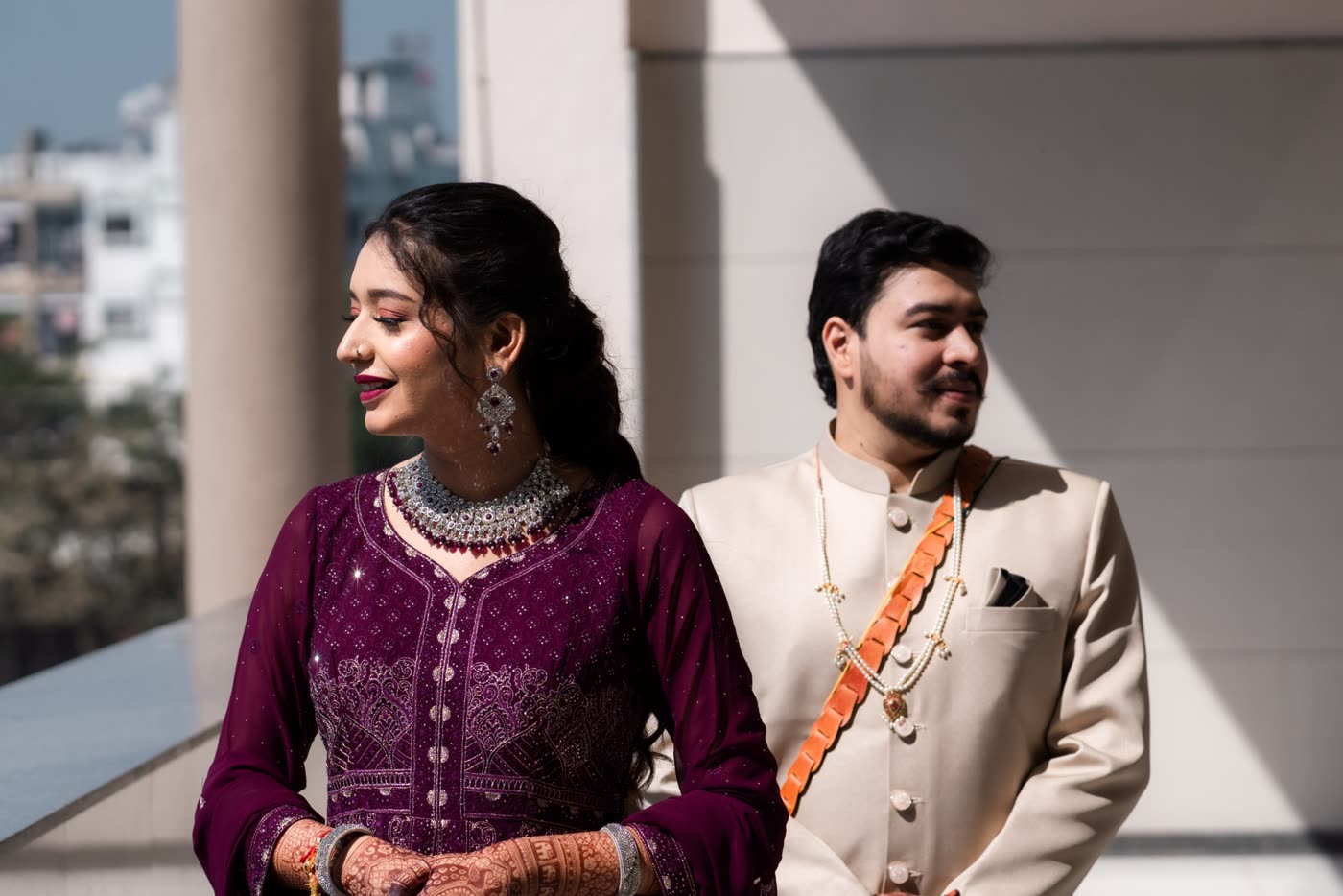 A couple outdoors in deep maroon
