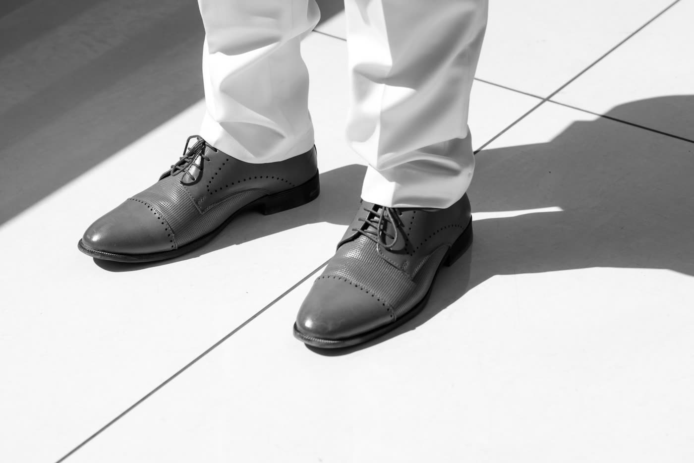 Polished shoes mid-step, in black and white